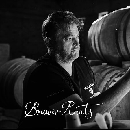 Winemaker inspecting barrels at Bruwer Raats winery in Stellenbosch.