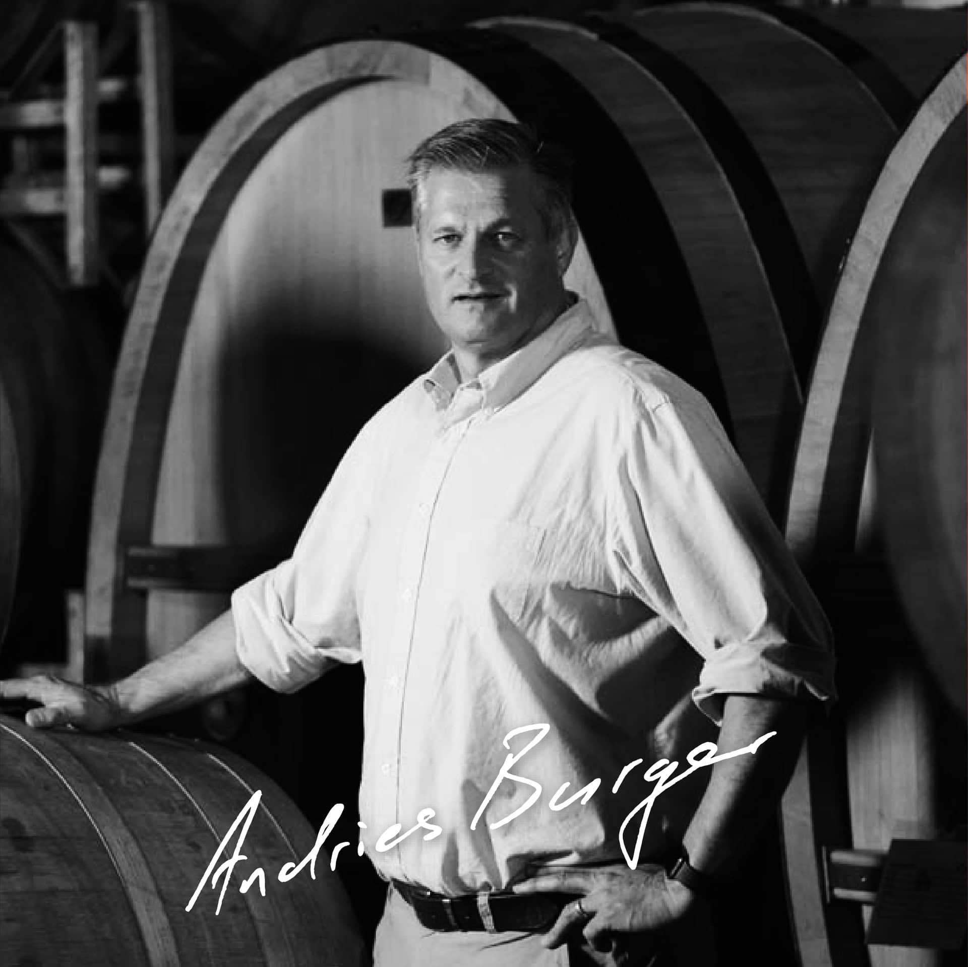 Andries Burger Standing Confidently Among Wine Barrels At Simon Wine Emporium.